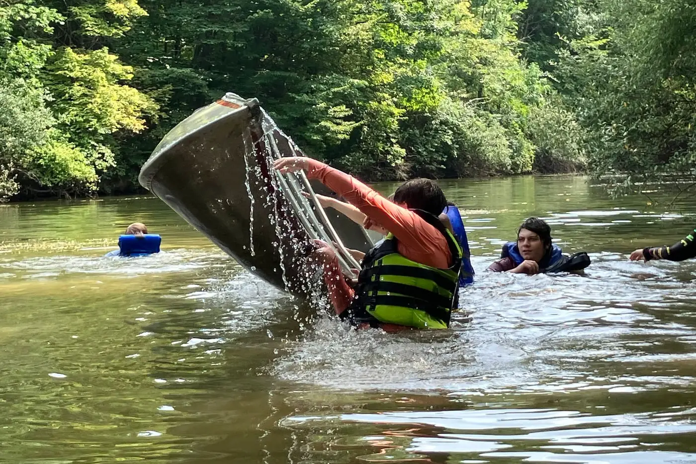 Scouts practicing canoe recovery on the water