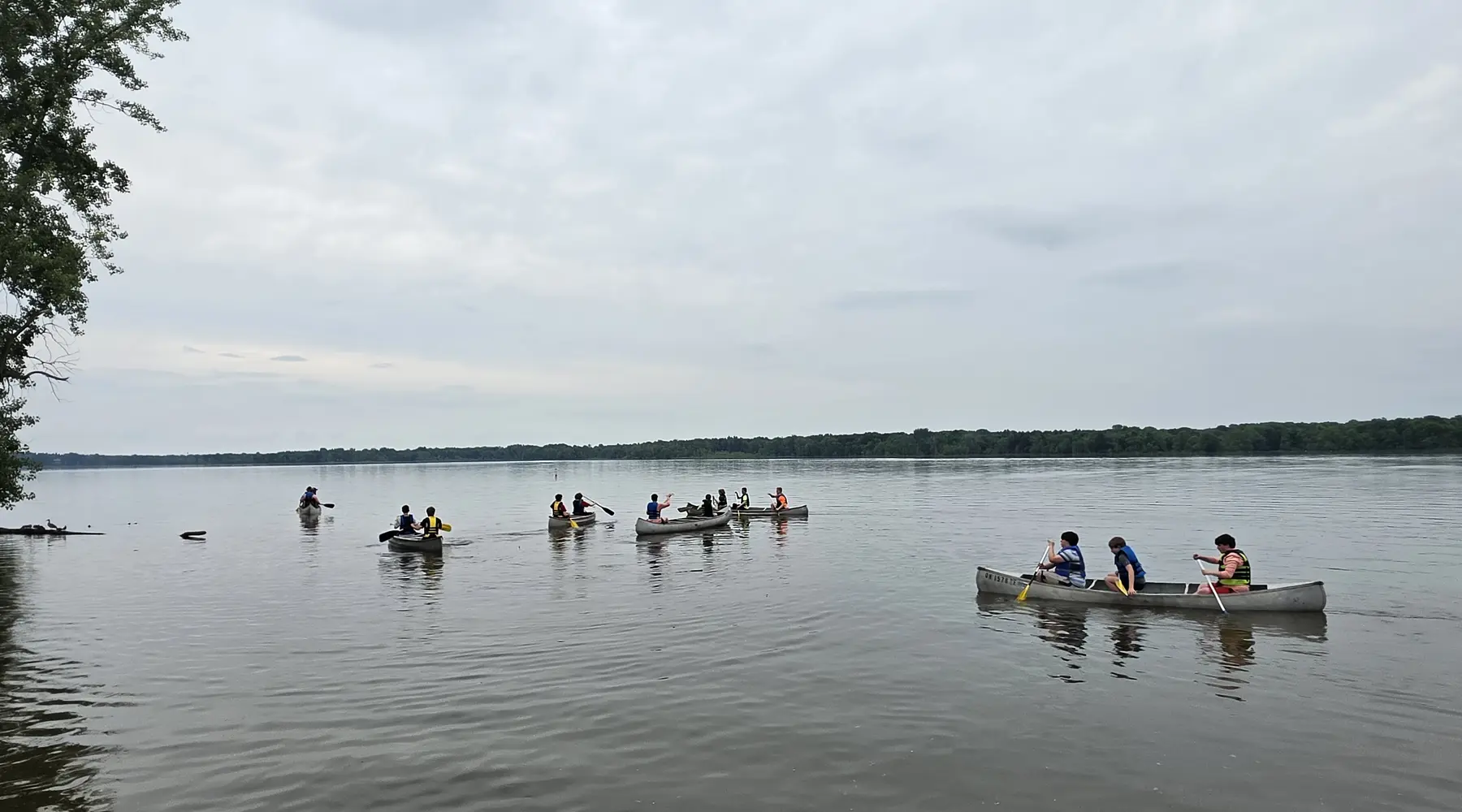 Troop canoes gathered on a lake