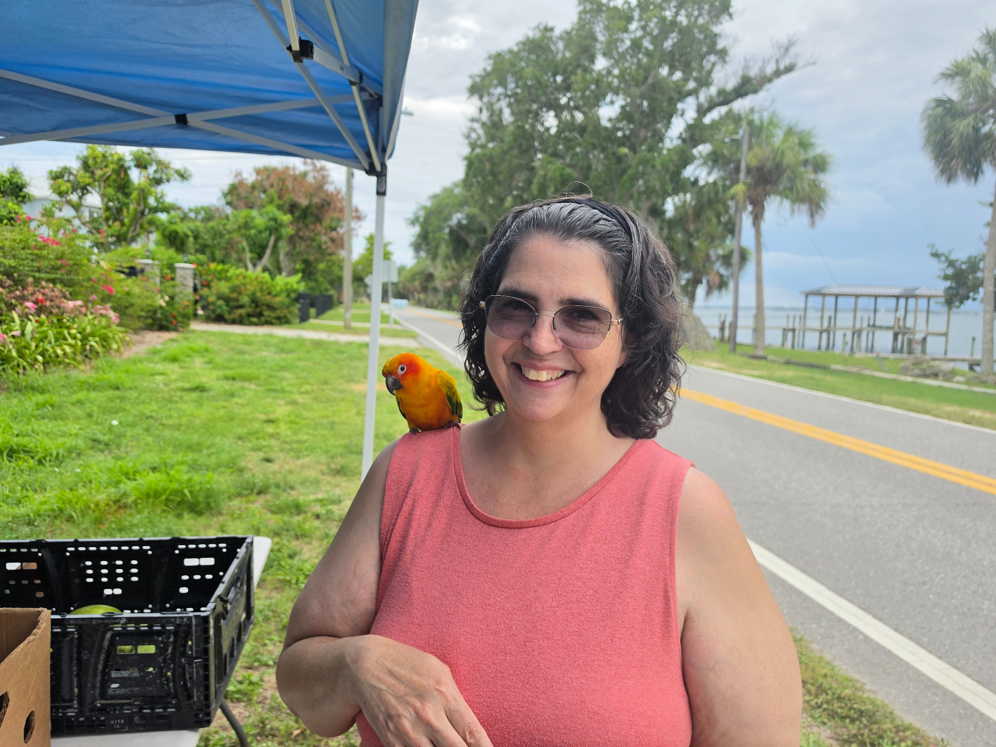 Melissa Belhorn, Troop 826 Committee Treasurer, smiling with a bird on her shoulder