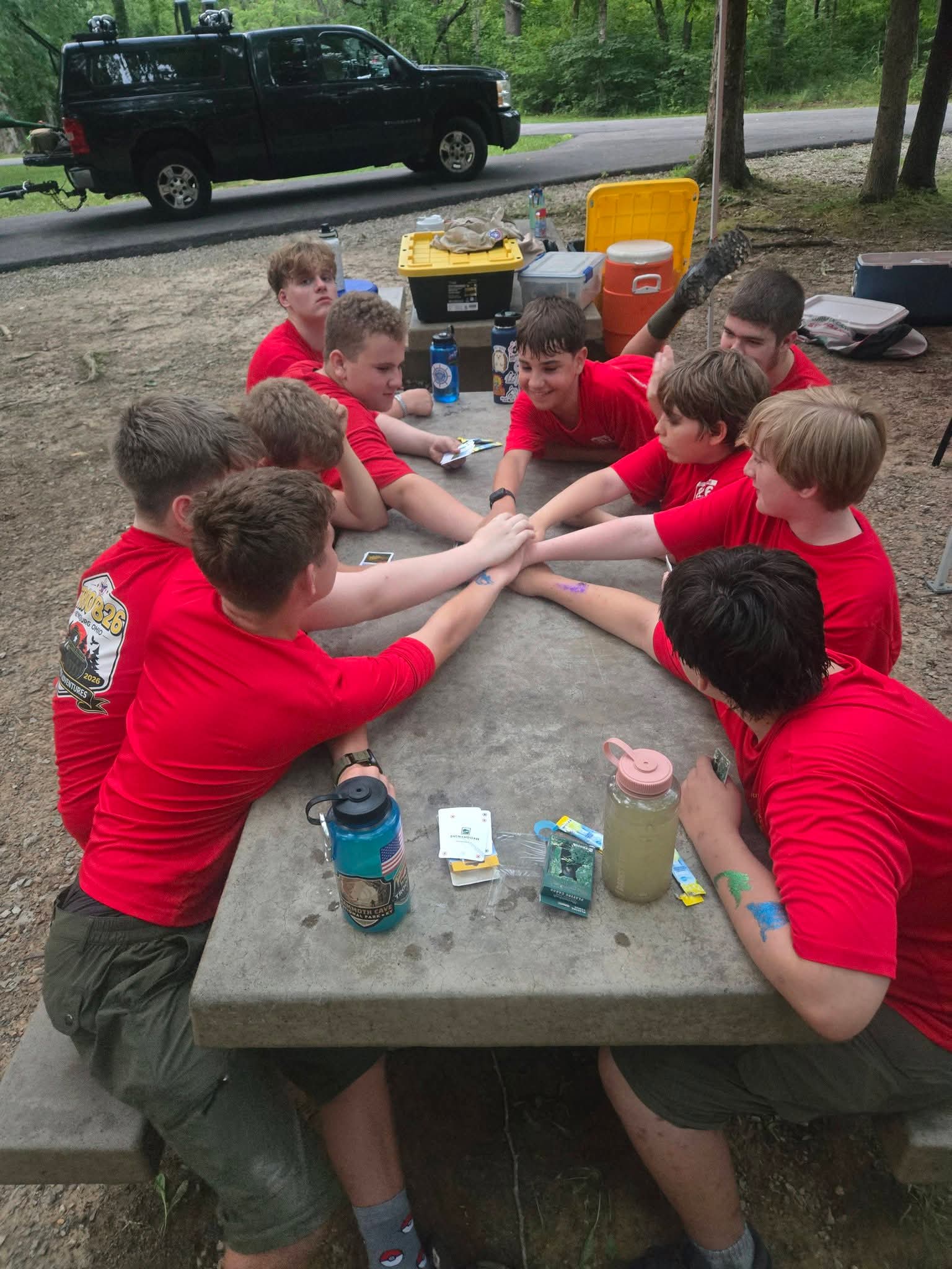 Troop 826 Scouts working together around a camp table