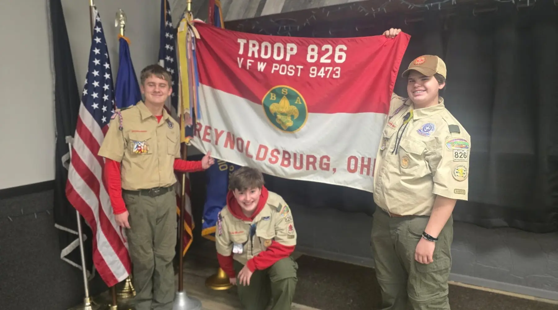 Troop 826 Scouts standing with the troop and VFW Post 9473 banner
