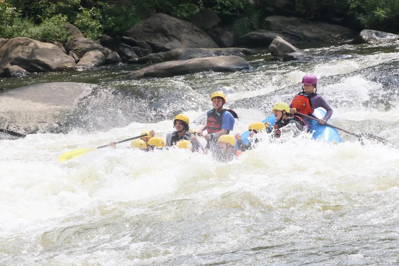 Scouts paddling together through whitewater