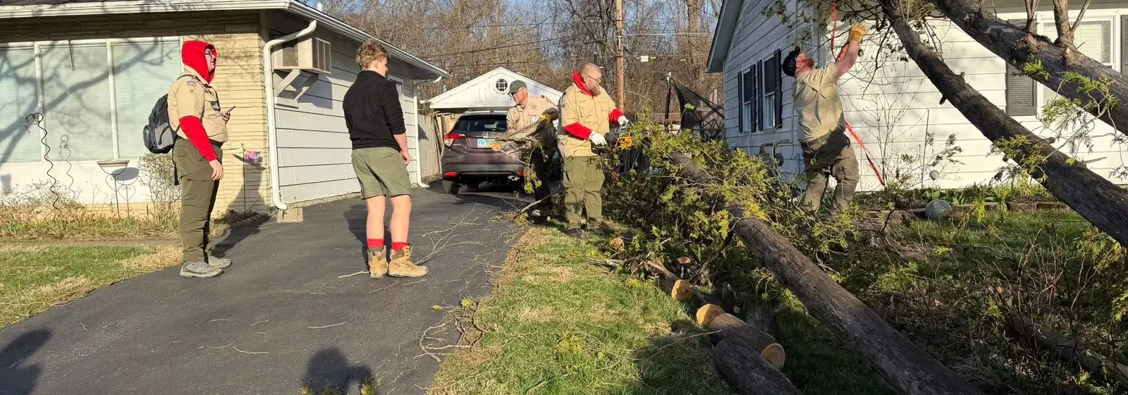 Troop 826 Scouts and adult leaders helping clear storm-damaged tree limbs in Reynoldsburg
